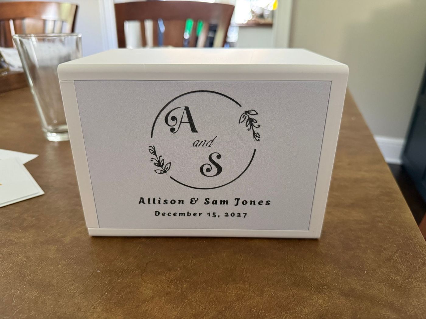 White 3D-printed wedding card box with a black monogram and names on the front